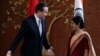 Chinese Foreign Minister Wang Yi (L) gestures to his Indian counterpart Sushma Swaraj before their meeting in New Delhi, June 8, 2014.