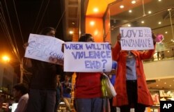 FILE - Indian students hold placards during a protest against the alleged molestation of a Tanzanian girl, in Bangalore, India on Feb. 4, 2016.