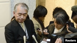 A Public Relations staff of JGC Corp answers reporters at its headquarters in Yokohama, in this photo taken by Kyodo, January 16, 2013.