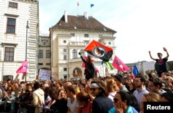 People protest in front of the Chancellery in Vienna, Austria, May 18, 2019.