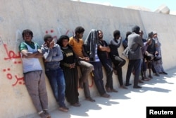 Migrants are seen after they were picked up by a coast guard patrol after a boat accident off the Libyan coast in Qarabulli town, east of the capital Tripoli, Libya, June 2, 2019.
