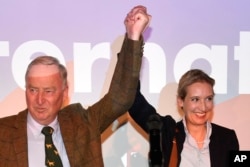 FILE - AfD top candidates Alexander Gauland, left, and Alice Weidel celebrate with their supporters during the election party of the nationalist Alternative for Germany in Berlin, Sept. 24, 2017.