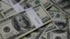 FILE - Bundles of U.S. $100 bills, Aug. 2, 2013. 