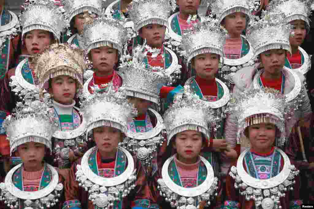 Ethnic Dong children wearing traditional costumes attend Duoye Festival, in Sanjiang, Guangxi Zhuang Autonomous Region, China.