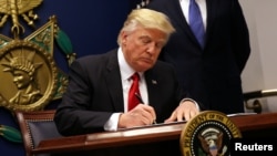 US President Donald Trump signs an executive order