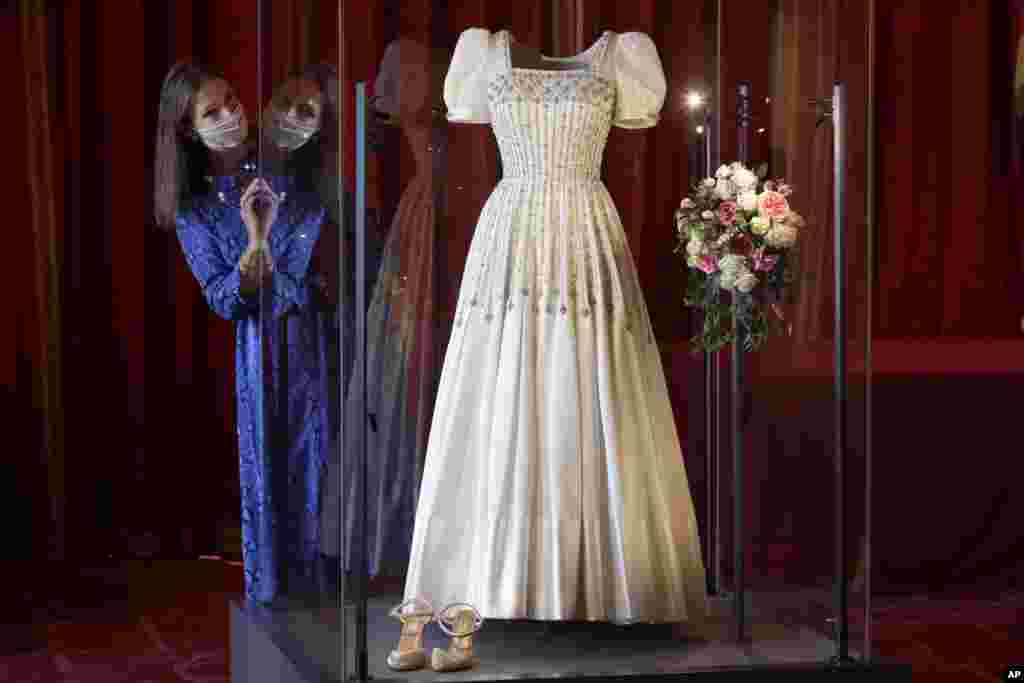 Caroline de Guitaut, Deputy Surveyor of The Queen's Works of Art, views Princess Beatrice's wedding dress, originally worn by Britain's Queen Elizabeth in the 1960s, ahead of it going on public display at Windsor Castle, Windsor, Britain.