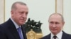 Russian President Vladimir Putin and Turkish President Tayyip Erdogan pose for a photo during a meeting in Moscow, Russia, March 5, 2020. 