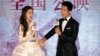 Hong Kong actress Angelababy and Chinese actor Jing Boran laugh during a press conference for the Chinese movie "Love O2O" in Beijing, Aug. 8, 2016.
