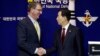 U.S. Defense Secretary Ashton Carter, left, shakes hands with his South Korean counterpart, Han Min Koo, after a joint news conference at the Defense Ministry in Seoul, South Korea, April 10, 2015. 