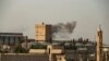 Smoke billows following Turkish bombardment on Syria's northeastern town of Ras al Ain in the Hasakeh province along the Turkish border, Oct. 9, 2019.