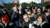 Mucella Yapici, one the defendants acquitted over their alleged role in Turkey's Gezi Park protests case, gestures as she is surrounded by supporters after leaving the Silivri courthouse complex, in Silivri near Istanbul, Turkey, Feb. 18, 2020.