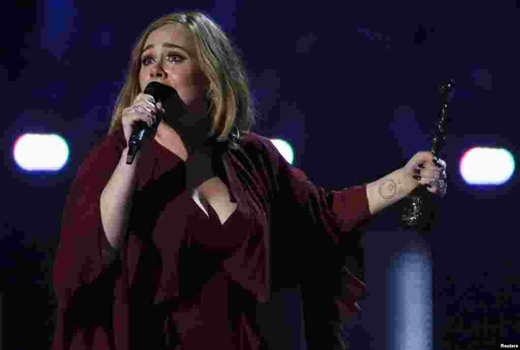 Adele reacts as she accepts the Global Success award at the BRIT Awards at the O2 arena in London, Feb. 24, 2016. Adele took four awards home, including best British female solo artist and best album.