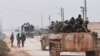 In this photo released by the Syrian official news agency SANA, shows government forces entering the village of Tel-Toukan, in Idlib province, northwest Syria, Feb. 5, 2020.