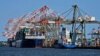 FILE - Container ships are docked at the Port of New York and New Jersey in Elizabeth, New Jersey, May 20, 2021.