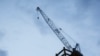 A crane is seen at a construction site during sunset hour in Taipei, Taiwan, on July 8, 2020.
