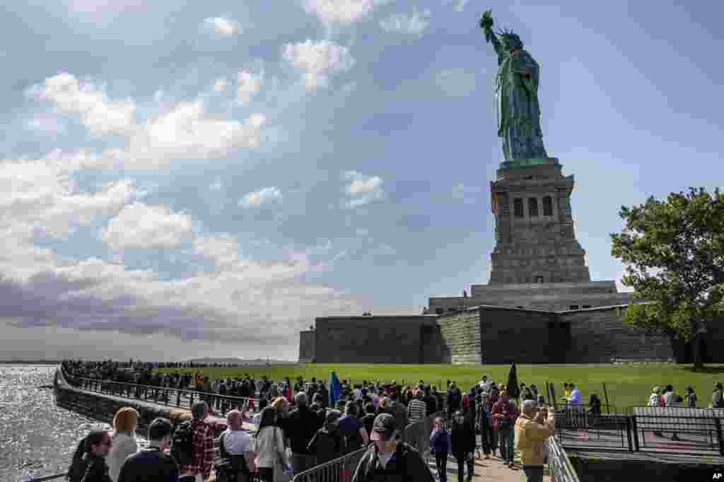 The Statue of Liberty looms over crowds of visitors on Liberty Island in New York Harbor, Sunday, Oct. 13, 2013, in New York.
