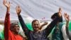 Aam Aadmi (Common Man) Party (AAP) chief and its chief ministerial candidate for Delhi, Arvind Kejriwal (C) waves to his supporters in New Delhi, February 10, 2015.