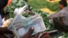 An Indian vegetable vendor counts rupees at a vegetable wholesale market in Allahabad, India, Nov. 21, 2013. 