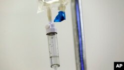 FILE - In this May 25, 2017 file photo, chemotherapy drugs are administered to a patient at a hospital in Chapel Hill, N.C. (AP Photo/Gerry Broome, File)