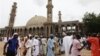 Nigerian Muslims walk past an uncompleted mosque in Maiduguri, Nigeria. Suspected Islamic militants wearing army fatigues gunned down 44 people praying at a mosque in northeast Nigeria, August 8, 2013.