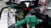 FILE - Gas is pumped into vehicles at a BP gas station in Hoboken, N.J., June 30, 2016. Federal regulators will review strict vehicle fuel efficiency standards finalized days before President Donald Trump took office.