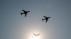 FILE - China's H-6 bomber jets fly in formation past the sun during a parade to commemorate the 70th anniversary of the founding of Communist China in Beijing, Oct. 1, 2019. 