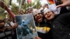 Supporters of Aam Aadmi (Common Man) Party (AAP) take part in the celebrations outside the AAP office in New Delhi, Feb. 10, 2015.