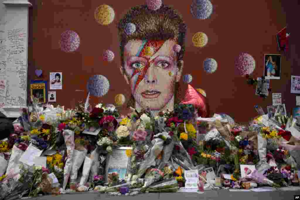 Tributes lie around a mural of British singer David Bowie by artist Jimmy C in Brixton, south London. Bowie, 69, died of cancer on Jan. 10.
