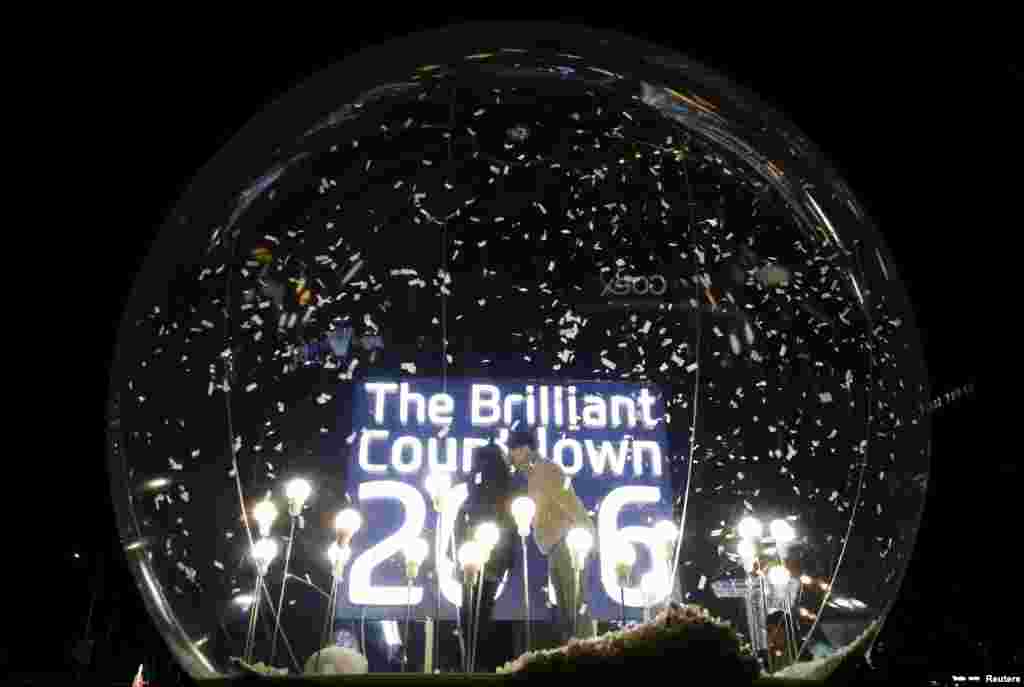 A couple kisses inside a giant inflatable ball during a countdown event to celebrate New Year in Seoul, South Korea.