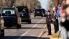 A young boy salutes as the hearse carrying the flag-draped casket of former President Jimmy Carter moves through downtown Plains, Georgia, Jan. 4, 2025. 