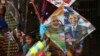 FILE - An Indian girl stands near a kite with portraits of India's Prime Minister Narendra Modi and U.S. President Barack Obama, for sale at a shop ahead of the Hindu festival Makar Sakranti, also known as kite festival, in Hyderabad, India, Jan. 12, 2015.