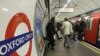 People board an underground 'Tube' train at Oxford Circus underground station in London. 