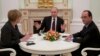 Russian President Vladimir Putin, center, meets with German Chancellor Angela Merkel, left, and French President Francois Hollande in Moscow, Feb. 6, 2015.