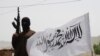 FILE - A Taliban fighter guards an area in Pakistan's South Waziristan tribal region, which borders Afghanistan, May 24, 2008. Sirajuddin Haqqani, the Taliban commander who allegedly operates out of Pakistan, has authored a rare opinion piece.