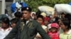 Thai police escort a group of Myanmar refugees crossing to Myawaddi town at the Thai-Myanmar border town of Mae Sot (File Photo)
