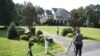 Photographers take photos of the house in Stafford, Va., of Oleg Smolenkov.