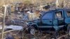 A vehicle sits among debris near Linden, Tenn., Dec. 24, 2015, following rare Christmastime tornadoes.