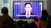 People watch a television airing a live broadcast of South Korean President Lee Myung-bak's retirement speech at Seoul Railway Station in Seoul, South Korea, February 19, 2013.