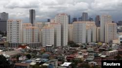 Rows of condominium buildings are seen behind a middle-class residential district in Mandaluyong, Metro Manila, July 4, 2012.