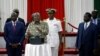 Kenya's President Uhuru Kenyatta, flanked by Kenyan Deputy President William Ruto and Opposition leader Raila Odinga launch the Building Bridges Initiative, a government report intended to address cyclical election violence in Nairobi, Nov. 27, 2019.