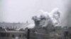This image made from amateur video released by Ugarit News and accessed June 17, 2012, purports to show smoke rising from buildings in Rastan town, in Homs province, Syria. 