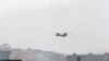 A CH-46 Sea Knight military transport helicopter flies over Kabul, Afghanistan, Aug. 15, 2021.