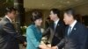 The head of North Korea's delegation Kim Song Hye, center, shakes hands with South Korean delegate Kwon Young-yang, right, upon their arrival for a meeting at the southern side of Panmunjom, in Paju, north of Seoul, South Korea, June 9, 2013. (Photo relea