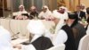 U.S., Taliban and Qatar officials are seen during a meeting for peace talks in Doha, Qatar in this undated handout photo.