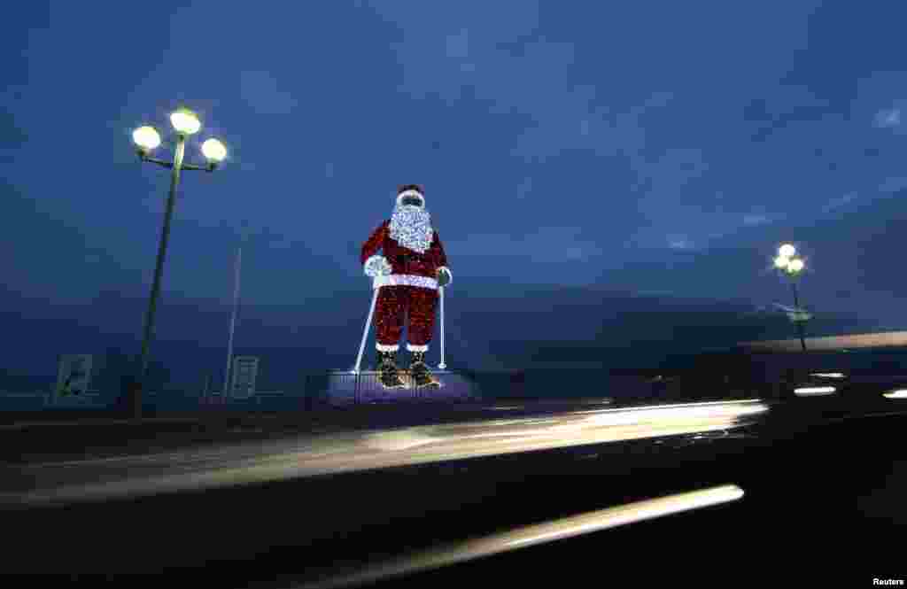 A giant illuminated Santa Claus is seen on the Promenade Des Anglais as part of holiday season decorations in Nice, France.
