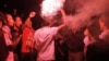 Flares illuminate the gathering of several hundred Third Square supporters. (Hamada Elrasam/VOA)