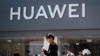 People walk past a Huawei retail store in Beijing, Sunday, June 30, 2019. Once again, Presidents Donald Trump and Xi Jinping have hit the reset button in trade talks between the world's two biggest economies, at least delaying an escalation in…
