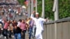 An Egyptian man throws a stone during clashes between rival groups of protesters in Cairo, Egypt, Friday, April 19, 2013. 