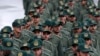 FILE - Iranian Revolutionary Guard members arrive for a ceremony celebrating the 40th anniversary of the Islamic Revolution, at the Azadi, or Freedom, Square, in Tehran, Iran, Feb. 11, 2019.