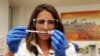 FILE - Felicity Hartnell, who is a clinical research fellow at Oxford University, holds a vial of an experimental vaccine against Ebola in Oxford, England, Sept. 17, 2014.